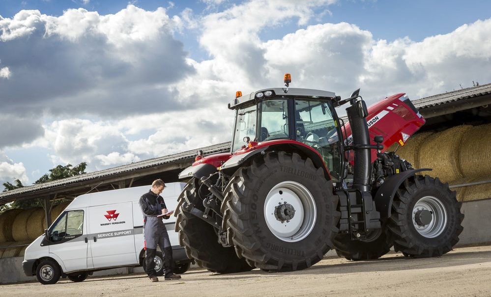 Mechanic servicing Massey Ferguson tractor
