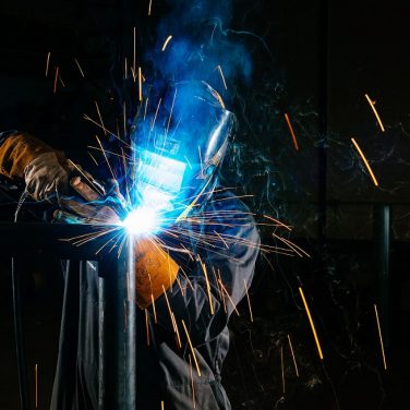 A welder welding a steel frame